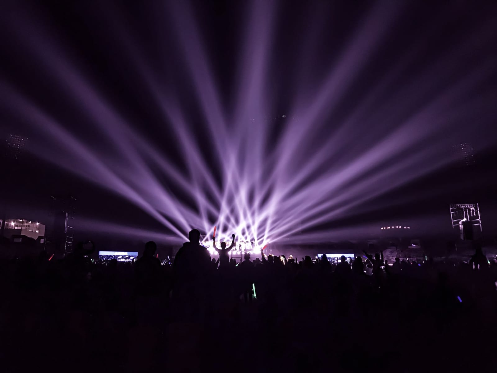 Concert crowd under coloured stage lights