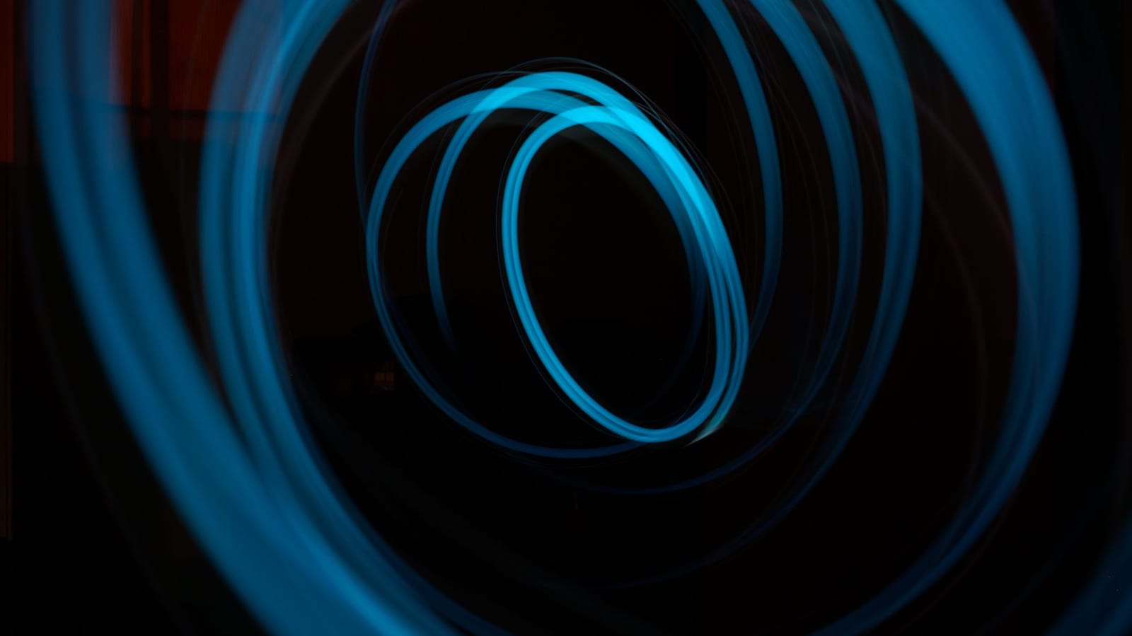 Glowing blue circles of light on a dark background
