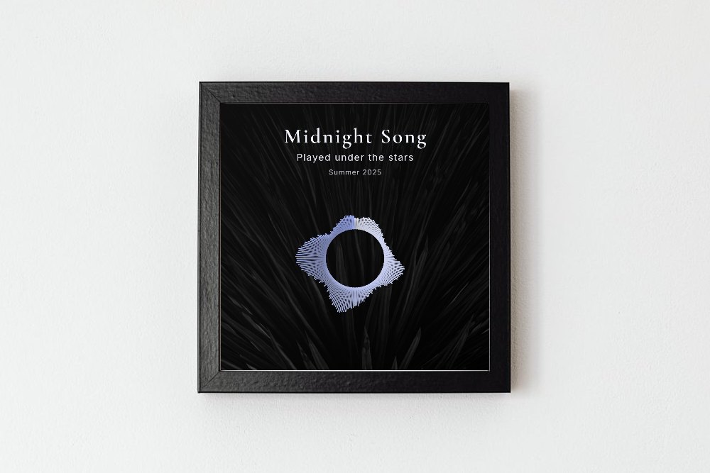 A square black frame on a white wall holding a silver circular sound wave on a dark background